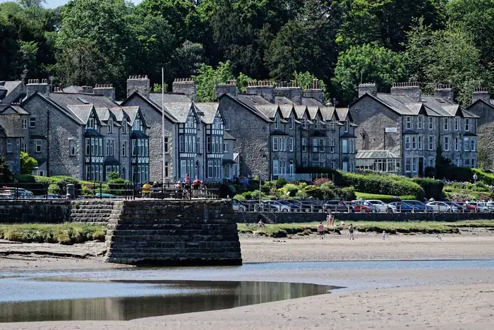 Exposed Cumbrian terrace facing an estuary, the kind of frontage that takes constant wind-driven rain