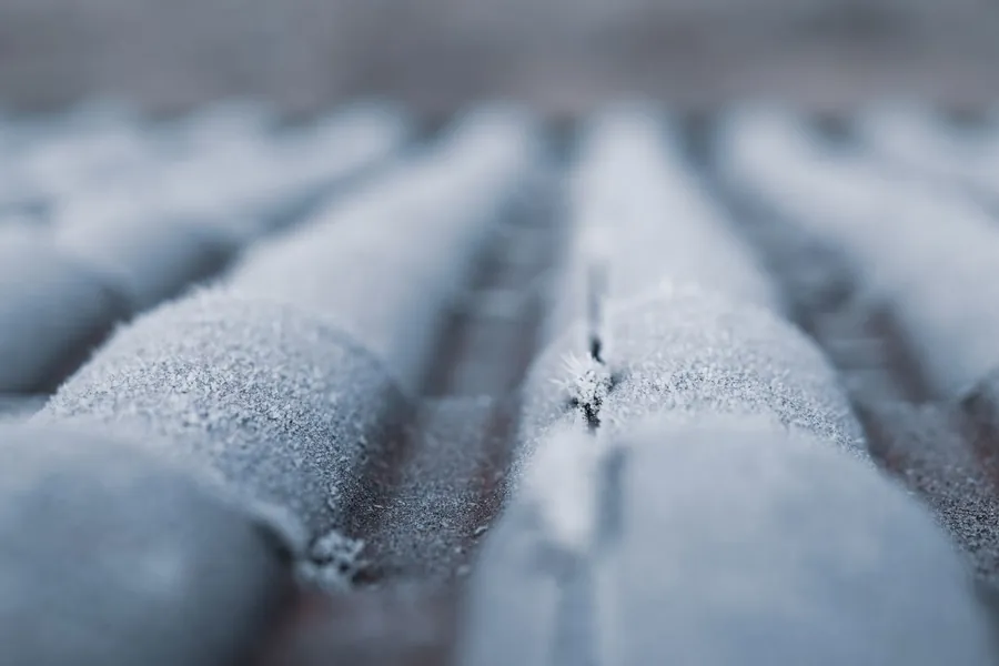 Roof tiles covered in a hard white frost on a cold winter morning in Carlisle