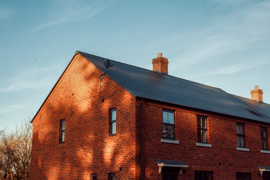 A traditional English brick house showing the gable end where the roof covering meets the wall at the verge