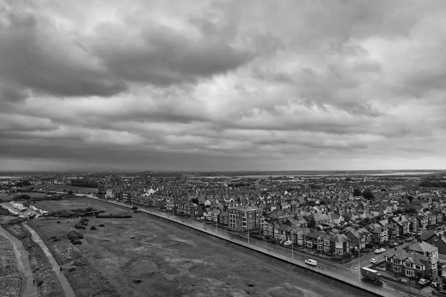 Heavy grey cloud building over a northern English town, the weather that brings emergency roof call-outs in Carlisle