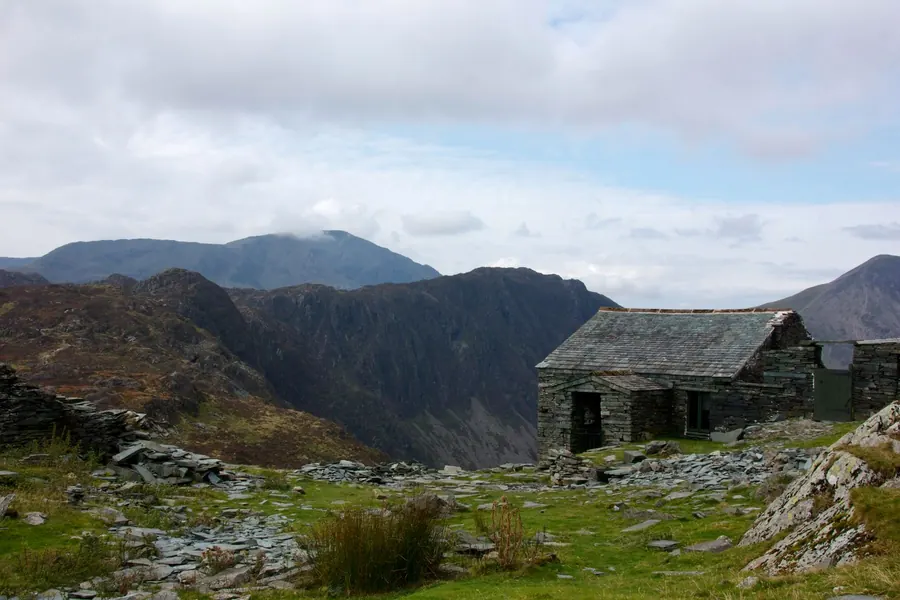 Stone building roofed in Lakeland slate among the Cumbrian fells, the heavier slate that costs more to match on a Carlisle roof repair