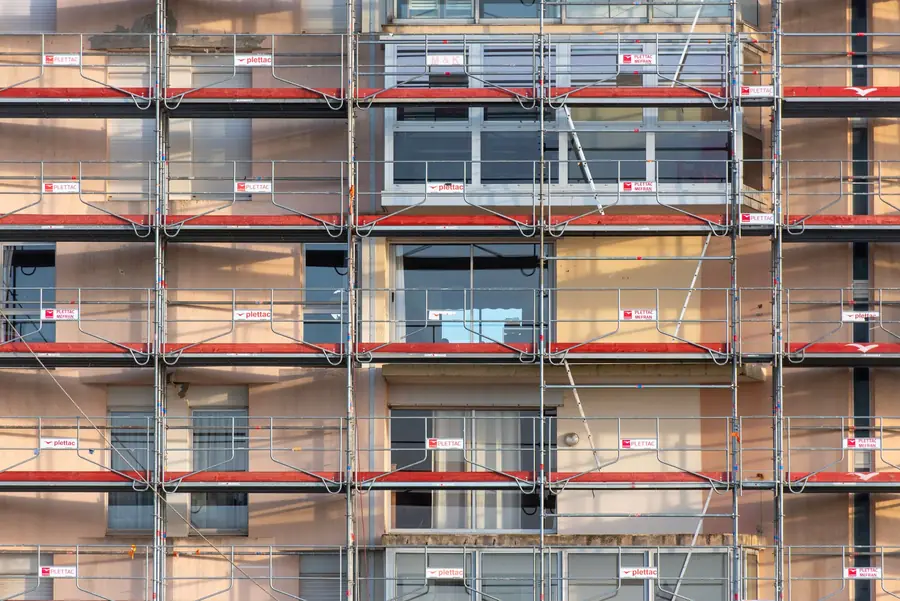 Scaffolding erected against a building facade, the access arrangement most Carlisle ridge and verge work needs