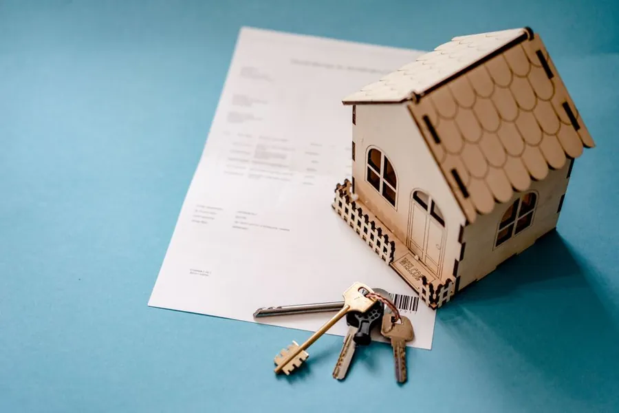 Mortgage paperwork and house keys, the stage at which spray foam in a Carlisle loft usually causes trouble