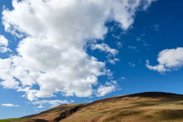 Open moorland fell under a blue sky, the empty Northern Fells country south of Wigton