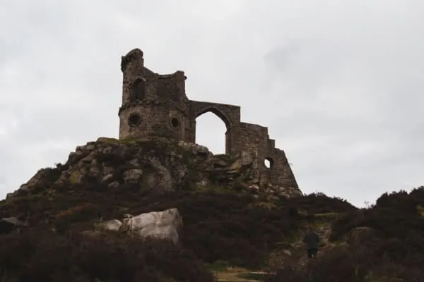 Hilltop castle ruins against a moody sky, the silhouette Kendal Castle cuts above the town