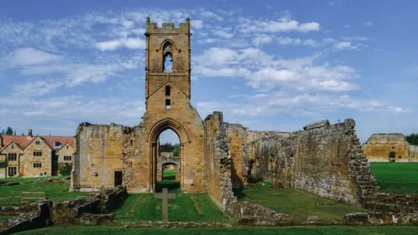 Sandstone priory ruins with a standing tower, the kind of scene Lanercost Priory presents