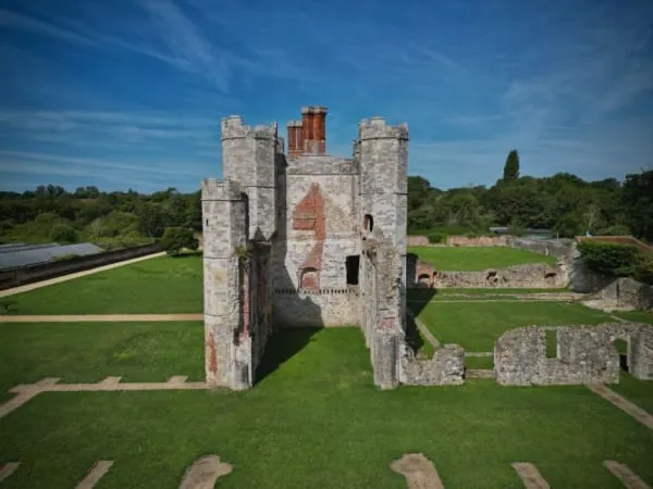 Ruined castle towers above lawns and gardens, the kind of scene Lowther Castle is known for