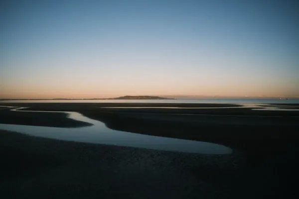 Tidal flats and channels at dusk on a wide estuary, the Solway shore near Gretna