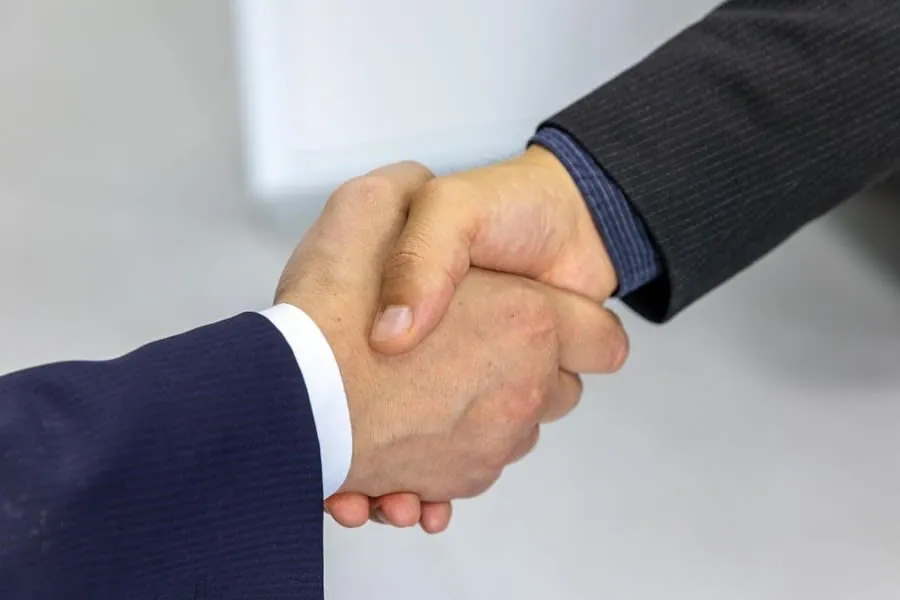 Shaking hands on agreed roofing work after the quote and paperwork have been settled in Carlisle