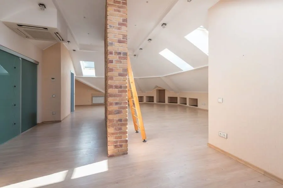 An attic room lit by two roof windows, the kind of space building regulations treat as habitable
