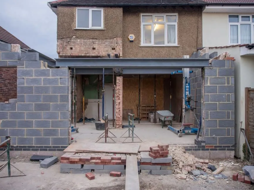 Building work under way at the rear of a semi-detached house, the disruption sellers weigh against a clean survey