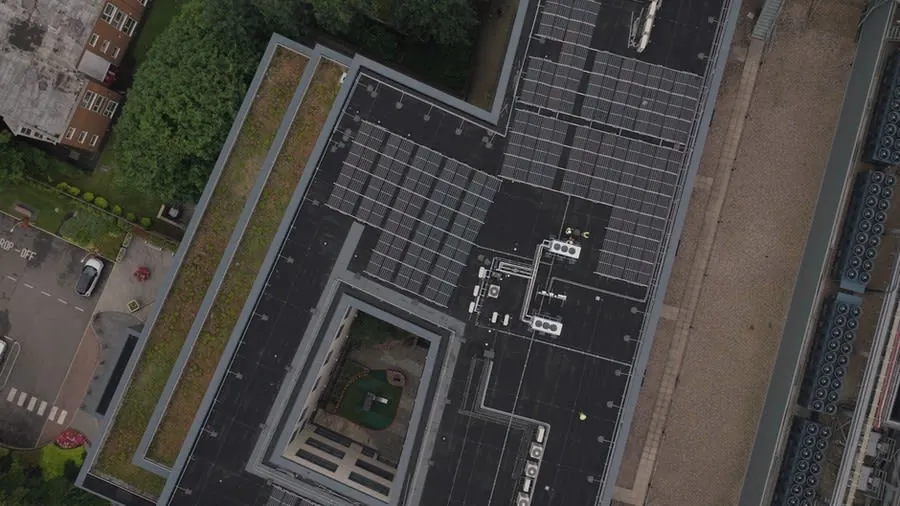 Aerial view of a large dark rubber membrane covering a flat roof