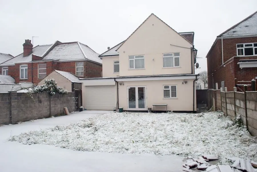 A residential street of older detached and semi-detached houses in winter, when a roof earns its keep