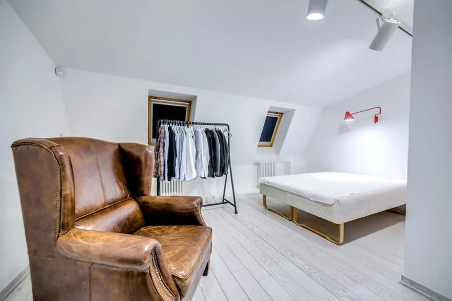 A finished loft bedroom lit by roof windows, the end result that justifies the disruption