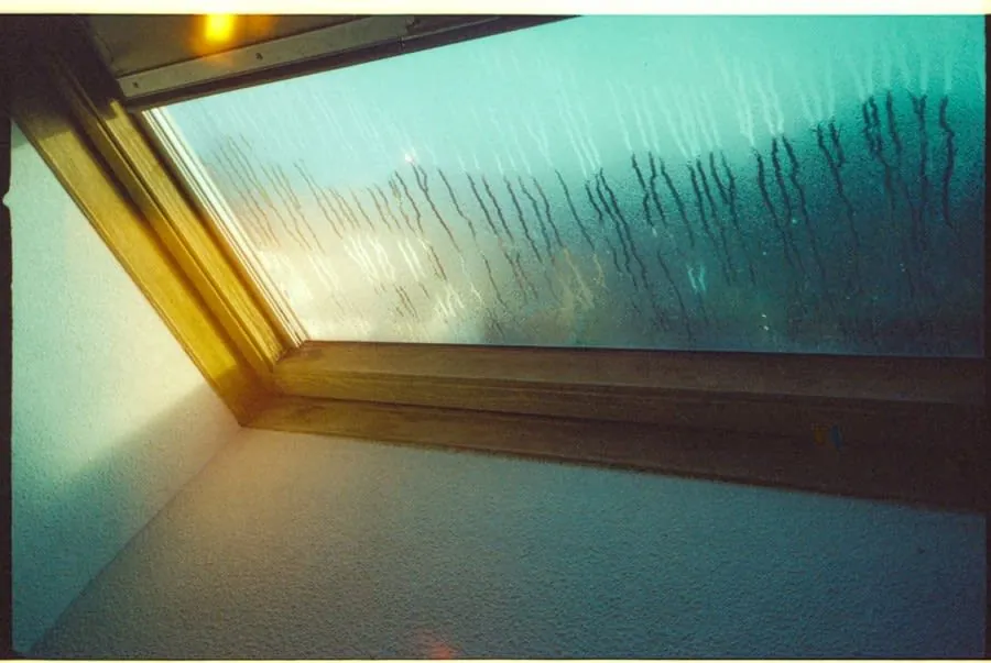Rain running down a rooflight above a loft space in Carlisle
