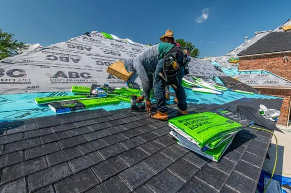 Roofer securing a damaged roof during an emergency call-out near Longtown