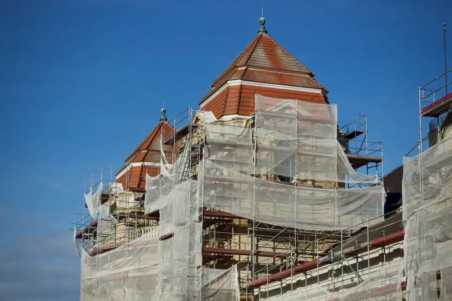 Scaffolding erected around a building for roof repair work, the biggest single cost on a small Carlisle job