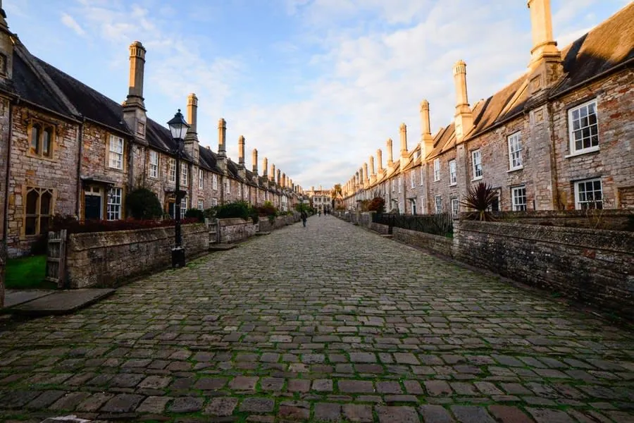 Historic stone terraced houses with tall chimneys, the kind of streetscape conservation rules exist to protect
