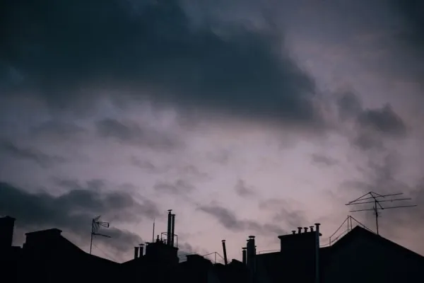 Storm clouds building over rooftops and chimney pots, weather Penrith gets funnelled up the Eden Valley