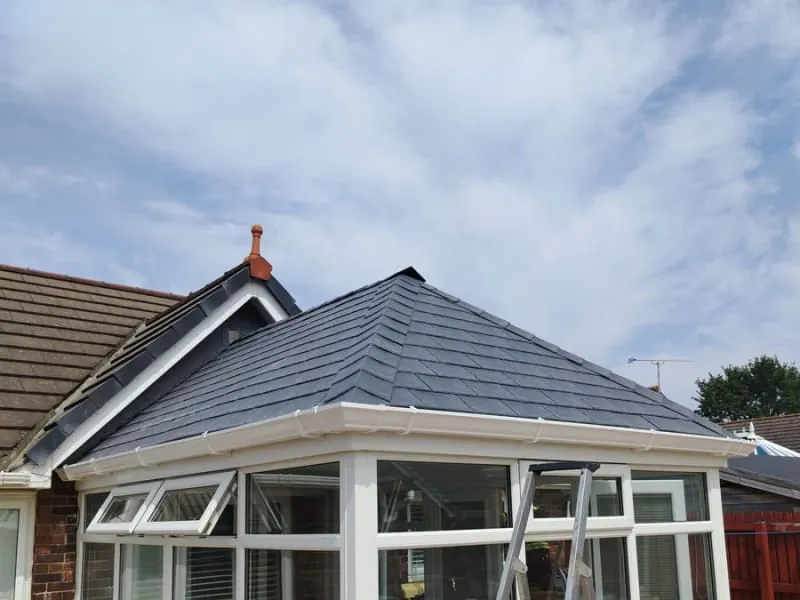 Conservatory roof replacement in progress with the new tiled covering being laid