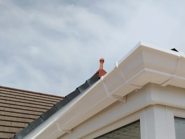 New white fascia, soffit and guttering fitted along a roof edge in Carlisle