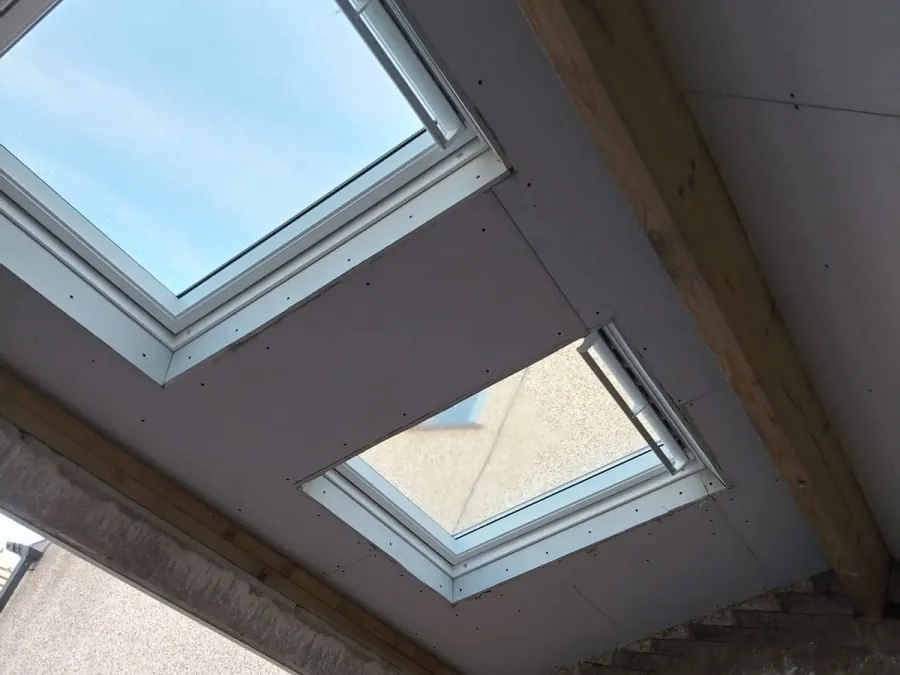 Daylight flooding through newly fitted roof windows into a loft room in Carlisle