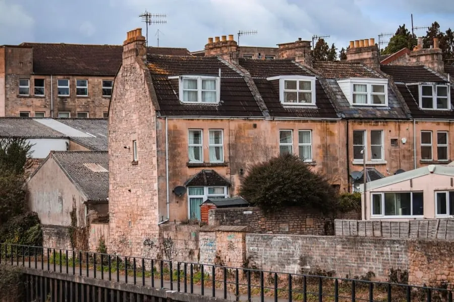 Slate rooftops and chimney stacks across a row of houses in Carlisle