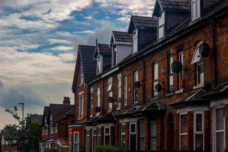 A street of terraced houses in Carlisle, the roofs a buyer walks past without looking at
